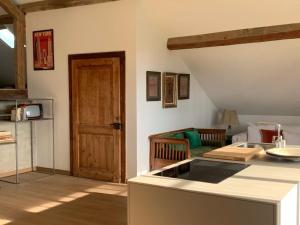 a kitchen with a counter top and a living room at 'Le Petit Clos Suites'- Charming Getaway on Leman Lake in Nyon
