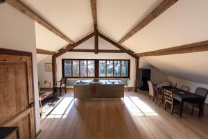 an attic room with a table and a dining room at 'Le Petit Clos Suites'- Charming Getaway on Leman Lake in Nyon
