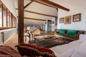 a living room with a couch and a table at 'Le Petit Clos Suites'- Charming Getaway on Leman Lake in Nyon