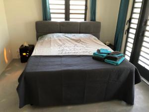 a bedroom with a bed with two towels on it at KasDes Bonaire in Kralendijk +38 photos
