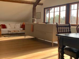 a living room with a couch and a table at 'Le Petit Clos Suites'- Charming Getaway on Leman Lake in Nyon