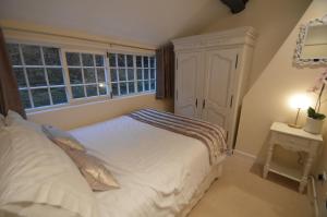 a bedroom with a white bed and a window at Wg Apartment in Macclesfield