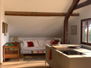 a living room with a couch and a table at 'Le Petit Clos Suites'- Charming Getaway on Leman Lake in Nyon