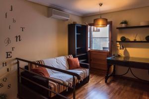 a living room with a couch and a piano at La Dama del Jardín del Nuncio in Toledo