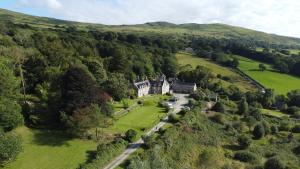 an aerial view of a castle in a green field at Maes Y Neuadd Country House in Talsarnau