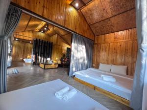 a bedroom with two beds in a wooden room at Vườn Mây Homestay Sapa in Sa Pa +110 photos