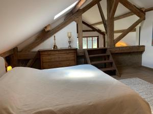 a bedroom with a large white bed and wooden beams at 'Le Petit Clos Suites'- Charming Getaway on Leman Lake in Nyon