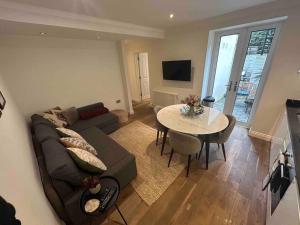 a living room with a couch and a table at Portobello 2-Bed Apartment in London