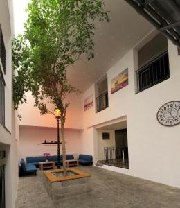 a living room with a tree in the middle of a building at Hostel Old Town in Bratislava