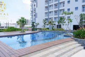 a swimming pool in front of a building at Royal Suites Studio 26RU - Citra Plaza Nagoya in Jodoh