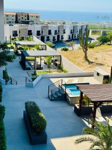 a patio with tables and benches on a building at Residencial Sabina in Cabo San Lucas