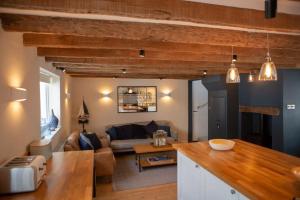 a living room with a couch and a table at St Margaret's Steps Luxury apartment sleeps 8 in Topsham
