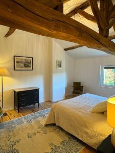 a bedroom with a large bed and a wooden ceiling at Maison Bordeaux Saint Émilion in Beychac-et-Caillau +60 photos