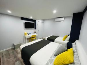a hotel room with two beds and a television at Hotel Libertad in Lares