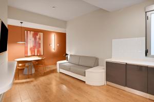 a living room with a couch and a table at B&B HOTEL Apartamentos Madrid Centro Fuencarral 46 in Madrid