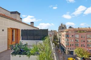 a view of a city from the balcony of a building at B&B HOTEL Apartamentos Madrid Centro Fuencarral 46 in Madrid