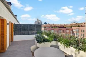 a balcony with chairs and a view of the city at B&B HOTEL Apartamentos Madrid Centro Fuencarral 46 in Madrid