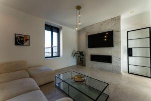 a living room with a couch and a fireplace at Maison élégante avec piscine in Tournon-sur-Rhône