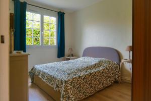 a bedroom with a bed and a window at maison au calme la chaume 6 personnes in La Chaume +19 photos