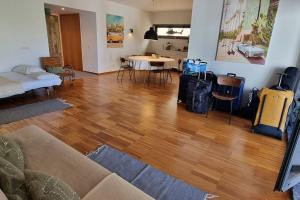 Lagos, Meia Praia Beach, Marina Apartment في لاغوس: غرفة معيشة مع أرضية خشبية صلبة وأريكة