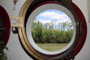 okrągłe okno z widokiem na zbiornik wodny w obiekcie Péniche Mirage-chambre d'hôtes w Carcassonne