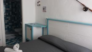 a bedroom with a bed and a blue table at Casetta del Pescatore in Polignano a Mare