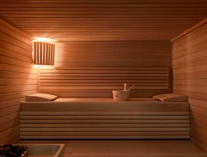 a sauna with two benches and a light on it at OKKO Hotels Cannes Centre in Cannes
