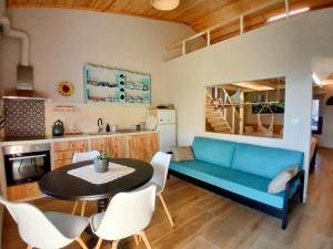 a living room with a blue couch and a table at Avdira Dreamin' in Xanthi