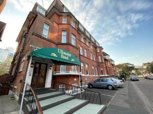 a building with a green awning in front of a building at Ullswater Hotel in Bournemouth