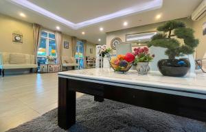 a living room with a table with a bowl of fruit at Baan Pattaya by Sabai in Pattaya Central +94 photos