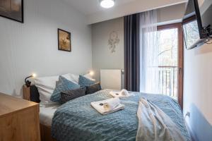 Posteľ alebo postele v izbe v ubytovaní Trevilles Apartamenty - Green Hills