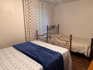 a bedroom with two beds and a wall with a wallpaper at Maison de vacances in Rivière-Rouge