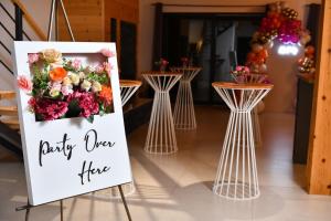 a sign for a party over fire with flowers at Vikendica Krcmarice- Banja Luka in Banja Luka