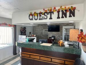 a fast food restaurant with a mustim sign above a counter at Quest Inn Weatherford in Weatherford