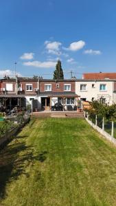 a house with a yard with a grass field at Escapade Cambresienne in Cambrai +59 photos