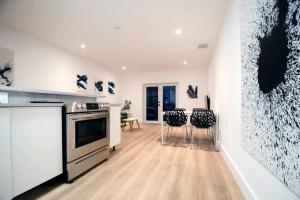 a kitchen with a stove and two stools at Casa Canal in North Miami Beach