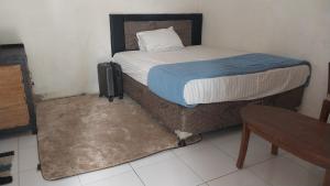 Кровать или кровати в номере Homestay larangga