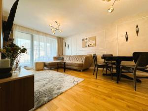 a living room with a couch and a table at Chic Center Apartament in Braşov