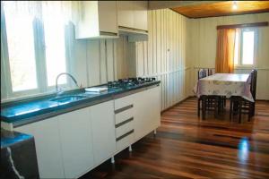 a kitchen with a sink and a counter top at Casa Lar Azul in Rio Forcação