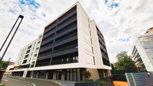 an office building with a black and white facade at Chic Center Apartament in Braşov
