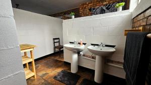 a bathroom with a sink and a toilet in it at 2K City Studios Not Self catering in Graskop