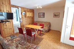 a living room with a table and a couch at Zam hus, monolocale walser in Macugnaga