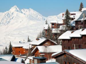 a village covered in snow with a mountain in the background at Studio-cabine 4 pers, proche pistes et commerces, balcon, piscine, 3 cristaux Paradiski - FR-1-455-27 in Plagne 1800