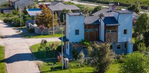 an overhead view of a blue house in a subdivision at Origen Rent a house in El Bolsón