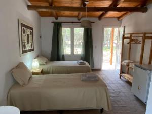 a bedroom with two beds and a window at Casa Natu- Naturaleza in San Marcos Sierras +20 photos