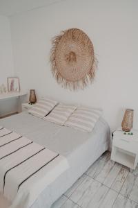 a bedroom with a bed with a wreath on the wall at El Nido in Azcuénaga +12 photos