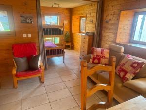 a living room with a couch and chairs in a cabin at Les Rottes, bas ferme proche Morillon Samoens avec SPA in Verchaix