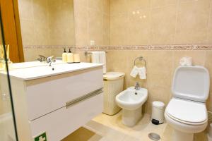 a bathroom with a toilet and a sink at Farinha's Apartment in Ribeira Brava +31 photos