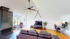 a living room with a couch and a fireplace at La Crête 65 - 3 chambres - 6 personnes in Saint-Férréol-les-Neiges