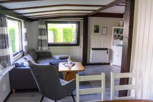 a living room with a couch and a table and chairs at Ferienwohnung zum Eiling in Bestwig